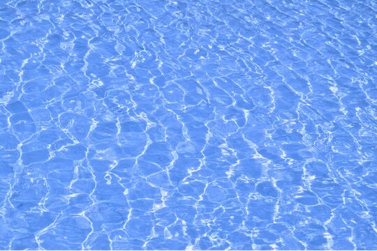 blue water in swimming pool at summer sunshine. 
