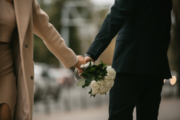 the bride and groom are holding a wedding bouquet in their hands