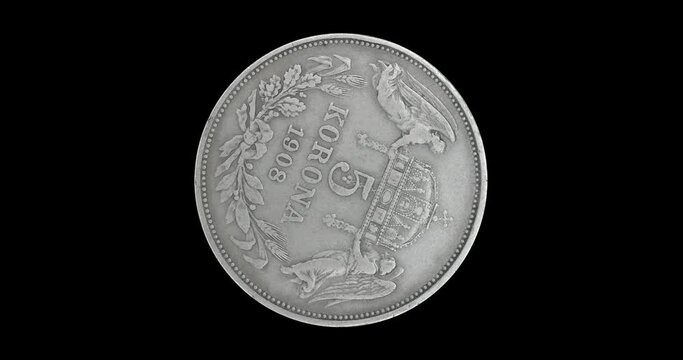 Obverse of old Hungary coin 5 korona 1908, isolated in black background. Loopable animation in 4k resolution video.