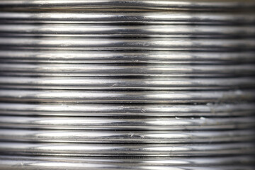 Close up of a coiled tin wire.