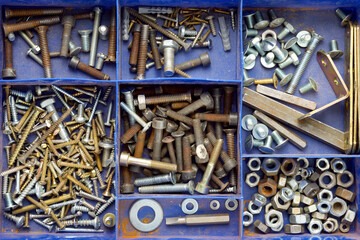 Group of screws and other metal fittings in a box