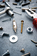 Tools, screws and other metal hardware on a workbench