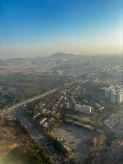 A city is seen from above with a hazy atmosphere