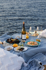 Shrimp, Seafoods, appetizers and salads on the table in Fish Restaurant. Beach Restaurant in Greece or Turkey. Aegean seaside, Greek or Turkish style fish restaurant in Bodrum, Santorini or Mykonos