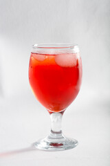 Red colored drink in a glass with ice macro photography as per likes of Rooh Afza and Jam e Shirin