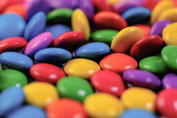 Fototapeta na wymiar Colorful chocolate candies background, macro shot