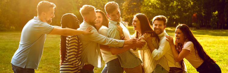 Group of happy joyful young diverse people multiracial friends meeting in sunny summer park, having...