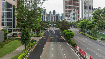 Traffic with cars on a street and urban scene in the central district of Singapore timelapse