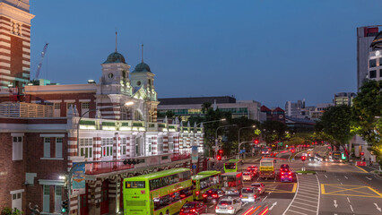 Street traffic near the fire station of Singapore day to night aerial timelapse.