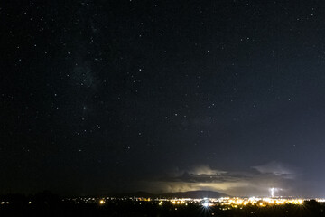 Starry Sky Cityscape with Lightning