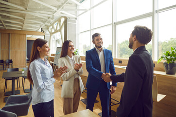 Business people meet new office colleague, handshake to greet, congratulate. Managers create high-performing workplace environment, human resources leader staffing, attracting and selecting talent
