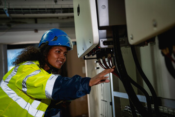 Engineers inspected the electrical switchboard and verified the operational voltage range. Technician setting electrical in inverter solar panel room