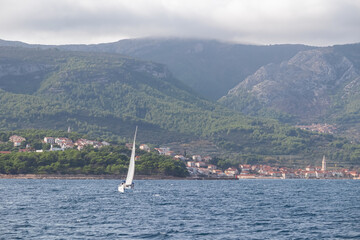 Luxury sailing boat arriving in coastal town Jelsa on Hvar island in Dalmatia, South Croatia,...