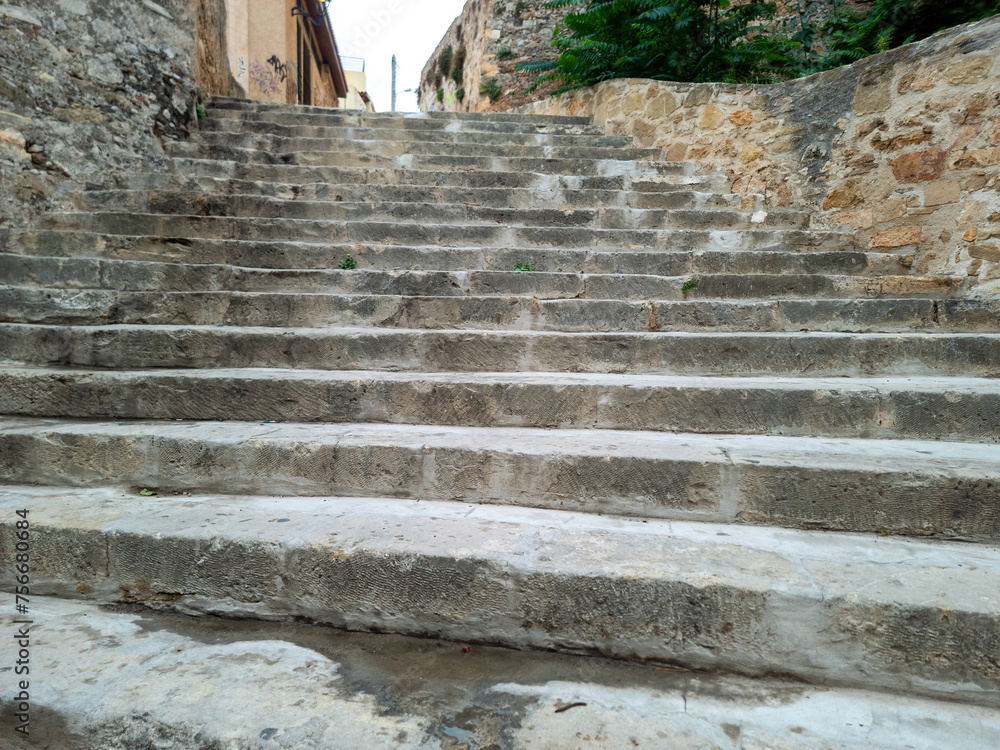 Canvas Prints old stone stair worn stonewall building, old town of chania crete island greece. blue sky background