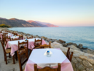 Outdoors traditional seaside taverna restaurant, Paleochora village afternoon in Crete island Greece