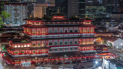 The Buddha Tooth Relic Temple comes alive at night timelapse in Singapore Chinatown, with the city...