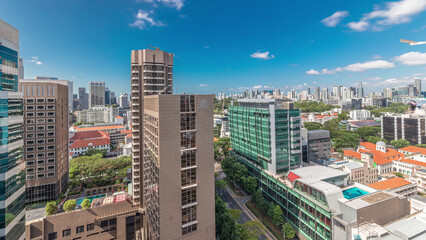 Naklejka premium Beautiful green Victoria street with city buildings skyline aerial timelapse in Singapore