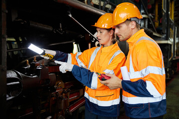 engineers or technicians using light stick and checking construction train at station