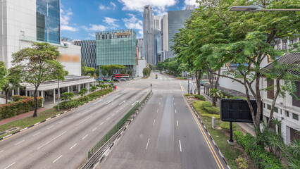 Traffic with cars on a street and urban scene in the central district of Singapore timelapse