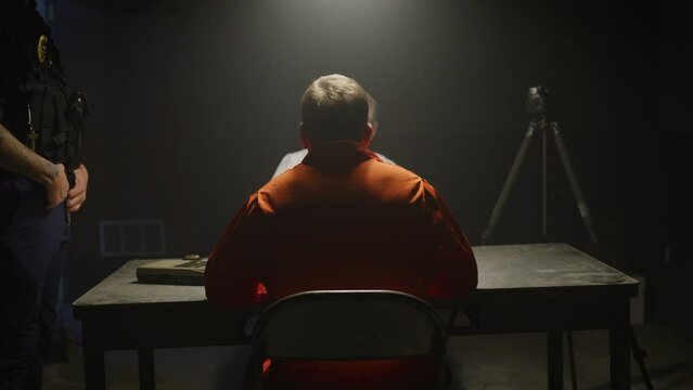 Detective interrogating inmate in prison jail