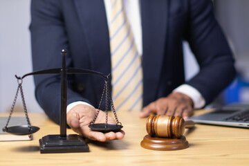 Brass scales are placed on lawyers desks in legal advice offices as a symbol of fairness and...