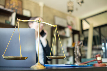 Brass scales are placed on lawyers desks in legal advice offices as a symbol of fairness and...