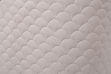 Scales pattern on beige velvet furniture, soft focus full frame abstract