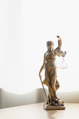 statue of god Themis Lady Justice is used as symbol of justice within law firm demonstrate truthfulness of facts and power to judge without prejudice. hemis Lady Justice symbol of honesty and justice.