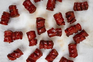 Fried sausage pieces soaking on paper towel tissue , saturated oils health problem
