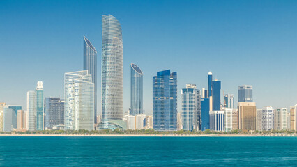 Obraz premium View of high skyscrapers on a corniche in Abu Dhabi stretching alongside the business center timelapse.