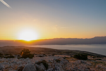 Watching sunrise from top of karst mountain peak Strazica near coastal town Baska, Krk Otok,...