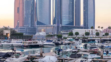 Gordijnen Al Bateen marina Abu Dhabi day to night timelapse with modern skyscrapers on background © neiezhmakov