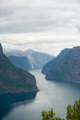 Nature view of Norwegian mountains from stegastein viewpoint on a cloudy summer day. Blue uv radiation on the mountains.