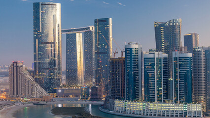 Buildings on Al Reem island in Abu Dhabi day to night timelapse from above.