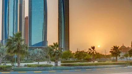 Gartenposter Skyscrapers of Abu Dhabi at sunset with Etihad Towers buildings timelapse. © neiezhmakov