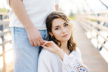 Woman holding mans arm on bridge