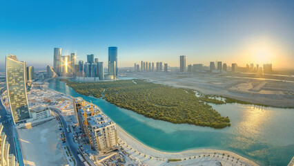 Buildings on Al Reem island in Abu Dhabi at sunset timelapse from above.