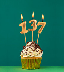 Birthday card with candle number 137 - Green background