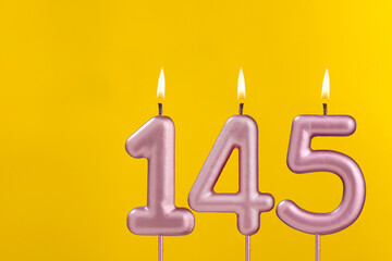 Candle 145 with flame - Birthday card on yellow luxury background