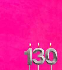 Candle number 130 - Birthday celebration on fuchsia background
