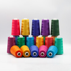 Thread spools background. Various colors sewing kit. Collection of threads. Vibrant vivid colors....