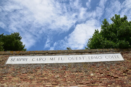 Recanati, Italy - June 19, 2023 - Famous wall of poet Giacomo Leopardi with text of his poem that means Always dear to me was this solitary hill.