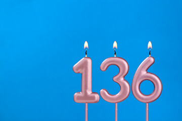 Birthday card with number 136 - Burning anniversary candle on blue background