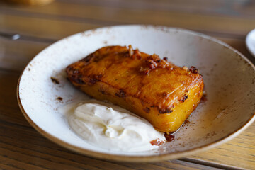 Potato casserole with sour cream and fried lard.