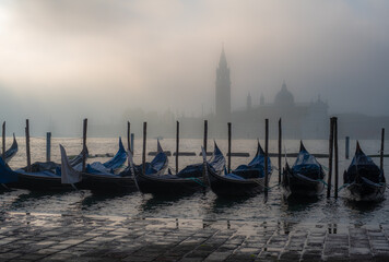 Gondolas in Venice at sunrise in morning fog. Veneto, Italy.. - 756702427
