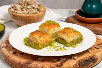 Baklava with pistachios on a wooden background. Turkish cuisine delicacies. Ramadan Dessert. local name kuru baklava