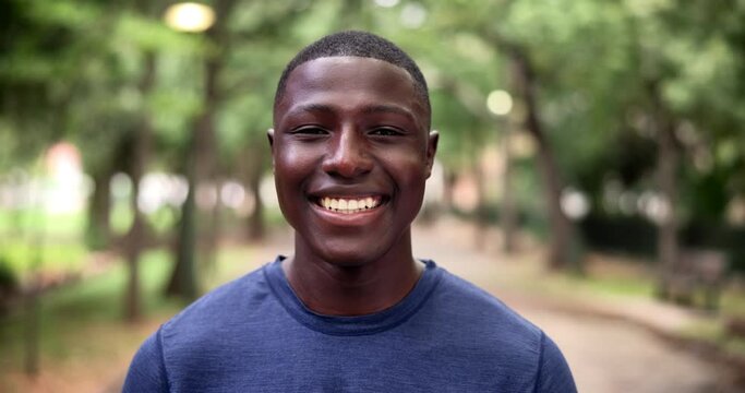 Man, face and smile in nature for workout exercise as athlete for running challenge or summer fitness, wellness or outdoor. Black person, portrait and training in woods environment, cardio or walk