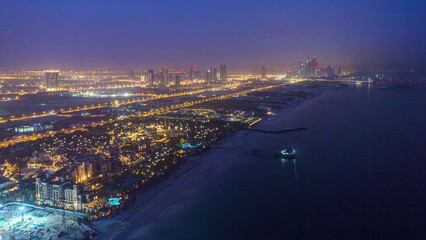 Skyline view of Dubai from night to day transition, UAE. Timelapse