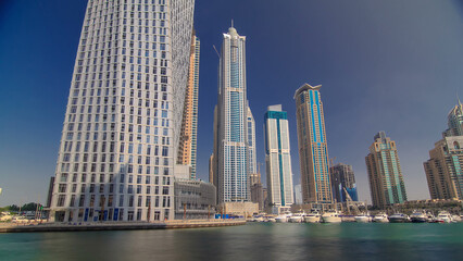 Dubai Marina with tallest skyscrapers and boats timelapse hyperlapse