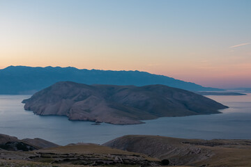 Panoramic sunrise view of deserted island Prvic seen from idyllic hiking trail near coastal town...